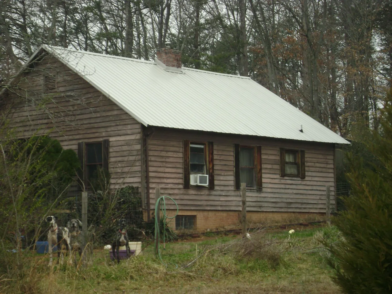 White metal roof on an old wood sided farmhouse, from a Asphalt Shingle Roof Repair job in Plainfield